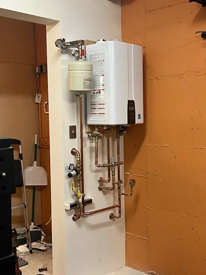 Plumbing technician inspecting water heater connections in Southampton